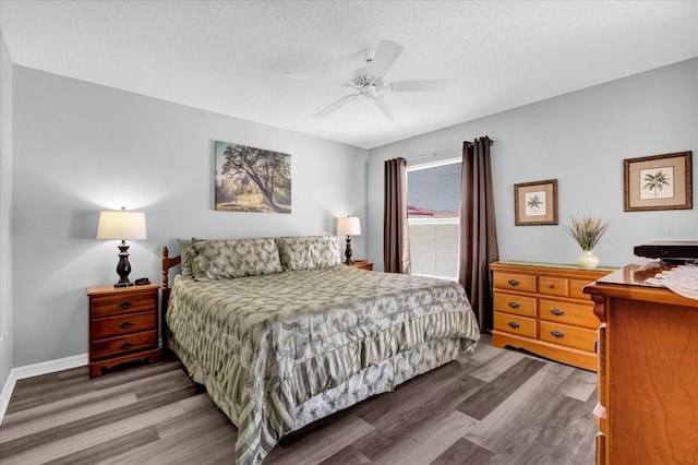 bedroom with ceiling fan, a textured ceiling, baseboards, and wood finished floors