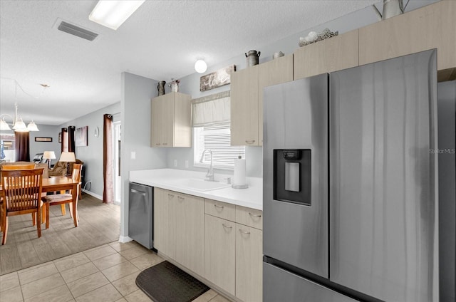 kitchen with light tile patterned floors, light countertops, visible vents, appliances with stainless steel finishes, and a sink