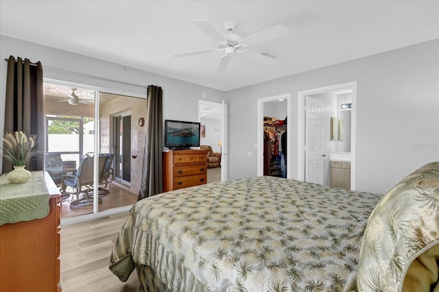 bedroom featuring access to exterior, a walk in closet, light wood finished floors, a closet, and ceiling fan