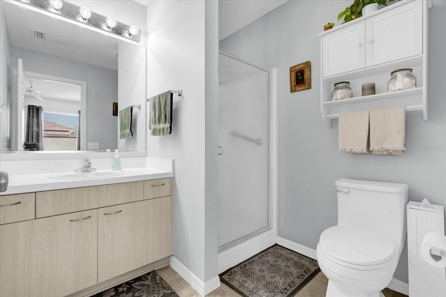 bathroom featuring toilet, a stall shower, visible vents, and vanity