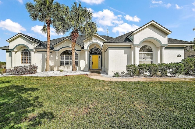 view of front of home featuring a front yard and stucco siding