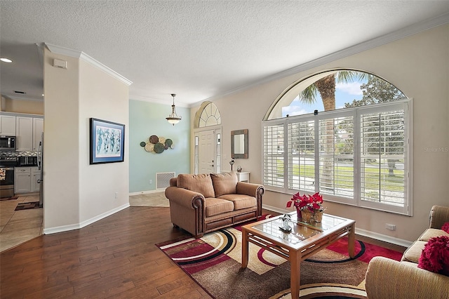 living room featuring dark wood-type flooring, crown molding, and baseboards