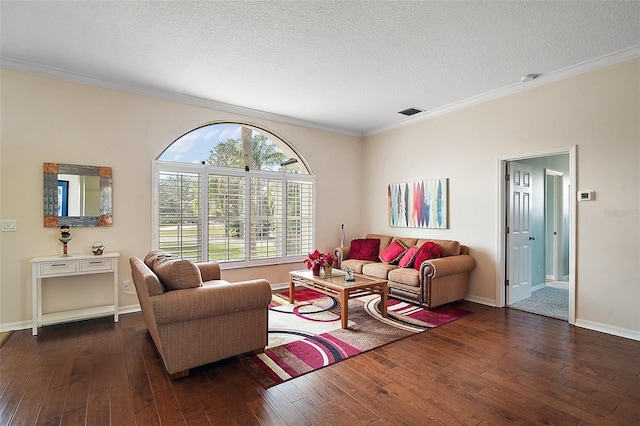 living area with a textured ceiling, dark wood-type flooring, ornamental molding, and visible vents