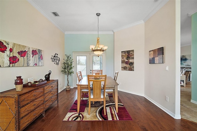 dining area featuring ornamental molding, baseboards, and hardwood / wood-style flooring