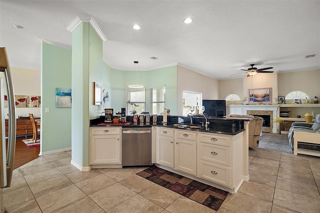 kitchen featuring light tile patterned floors, dishwasher, open floor plan, a fireplace, and a sink