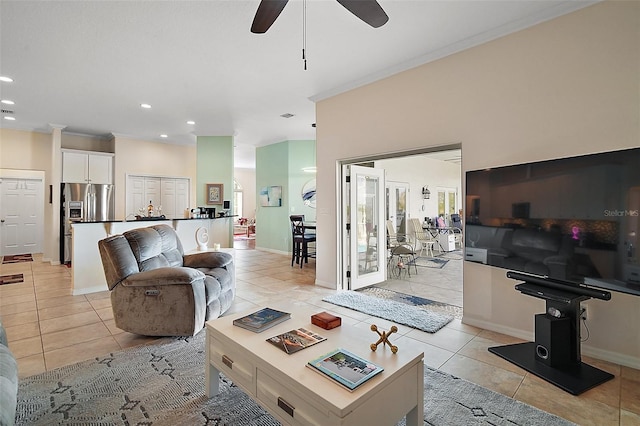 living room featuring light tile patterned floors, baseboards, crown molding, and recessed lighting