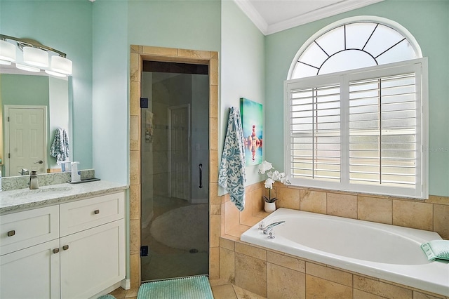 full bathroom featuring ornamental molding, a stall shower, a garden tub, and vanity