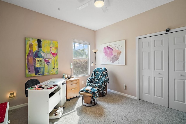 interior space featuring a ceiling fan, light carpet, and baseboards