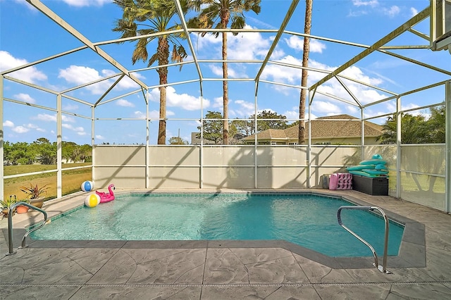 view of swimming pool featuring glass enclosure, a fenced in pool, and a patio