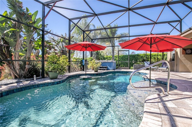 pool featuring a lanai, a patio area, and a hot tub