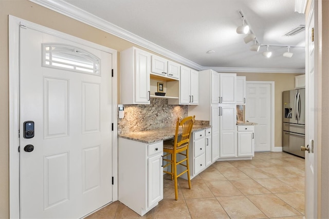 kitchen featuring ornamental molding, stainless steel refrigerator with ice dispenser, white cabinetry, and decorative backsplash