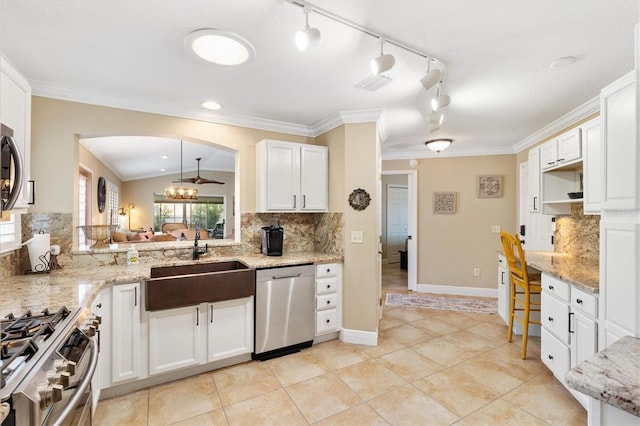 kitchen with stainless steel appliances, a sink, visible vents, white cabinetry, and ornamental molding