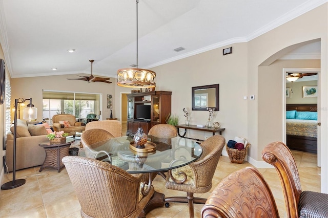 dining room with visible vents, arched walkways, ceiling fan, ornamental molding, and vaulted ceiling