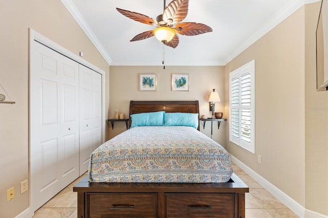 bedroom with light tile patterned floors, baseboards, ceiling fan, crown molding, and a closet