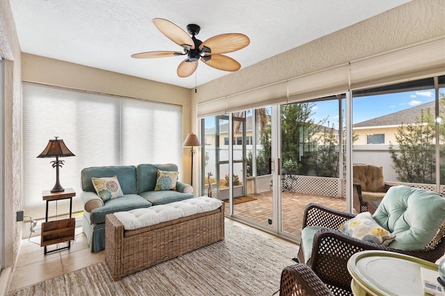 sunroom / solarium featuring a ceiling fan