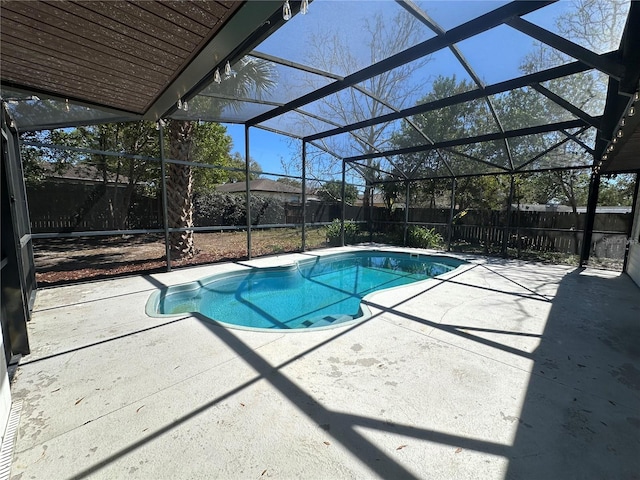 view of pool featuring a patio area, a fenced backyard, glass enclosure, and a fenced in pool