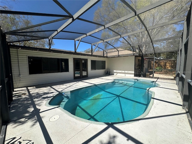 outdoor pool with a lanai, fence, and a patio