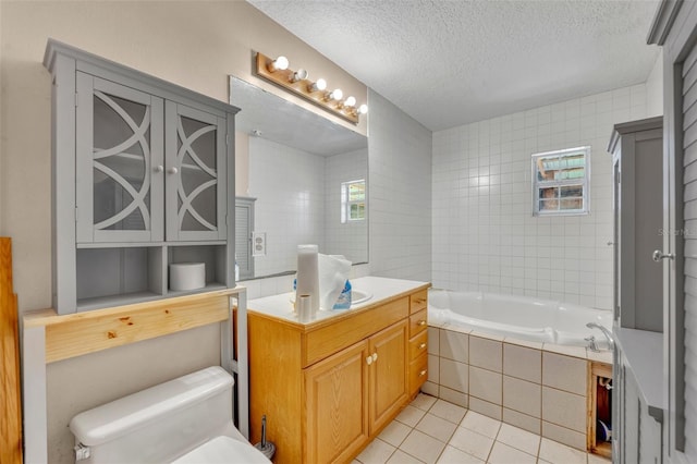 bathroom with tile patterned flooring, tiled bath, tile walls, toilet, and a textured ceiling