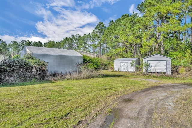 view of yard featuring an outbuilding and a storage shed