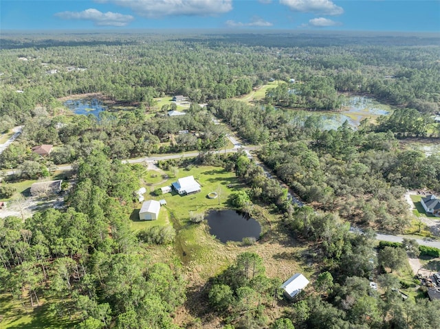 aerial view featuring a view of trees and a water view