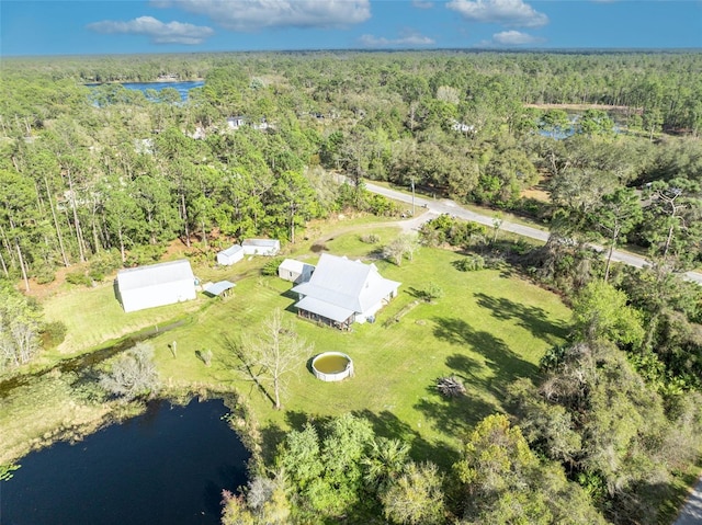 aerial view featuring a water view and a wooded view