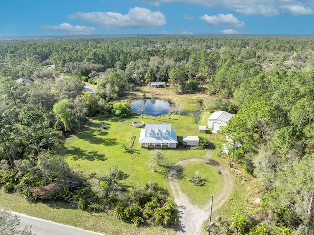 birds eye view of property featuring a wooded view