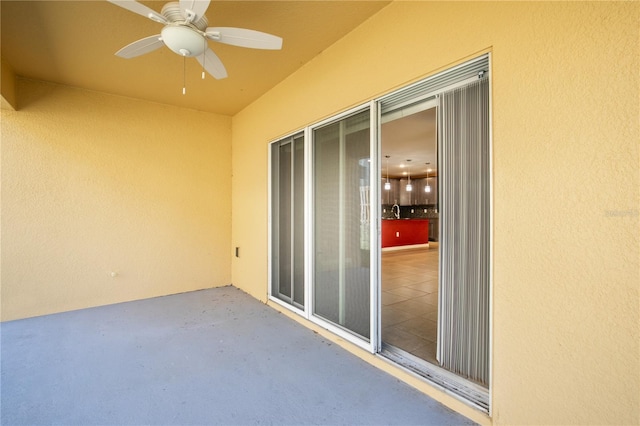 exterior space featuring a patio, a ceiling fan, and a sink