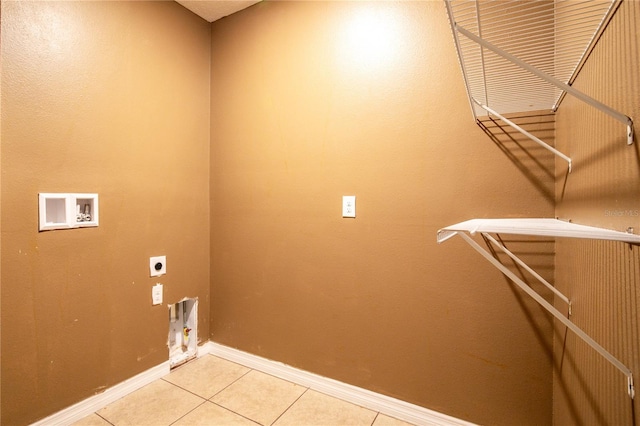 washroom featuring baseboards, light tile patterned floors, laundry area, hookup for a washing machine, and electric dryer hookup