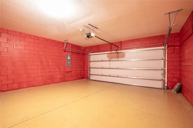 garage with electric panel, a garage door opener, and concrete block wall