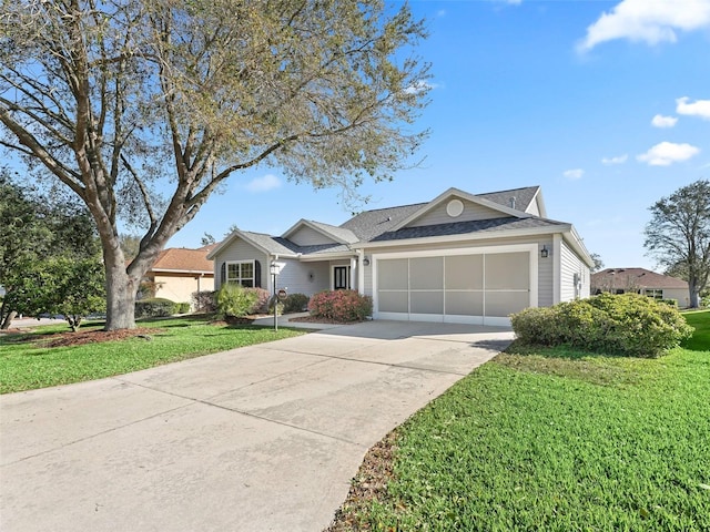 ranch-style house featuring a garage, a front yard, and concrete driveway