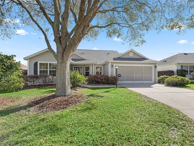 single story home featuring a garage, driveway, and a front yard