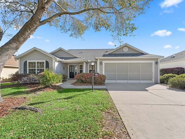 single story home with a garage, a front lawn, and concrete driveway