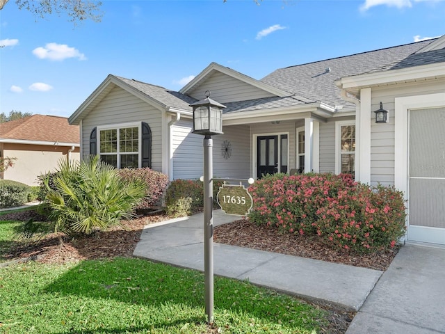 view of front of home featuring a shingled roof