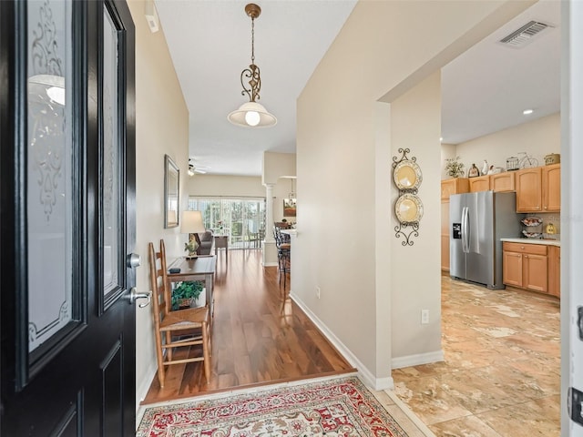 foyer featuring visible vents and baseboards