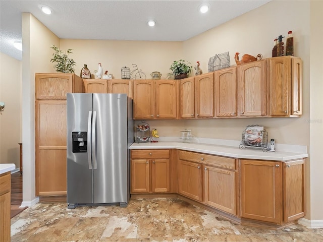 kitchen with recessed lighting, light countertops, and stainless steel fridge with ice dispenser