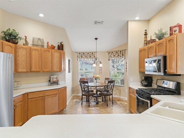 kitchen with stainless steel appliances, light countertops, visible vents, hanging light fixtures, and vaulted ceiling