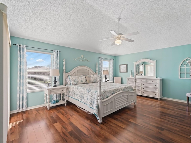 bedroom with a textured ceiling, dark wood-style flooring, a ceiling fan, and baseboards