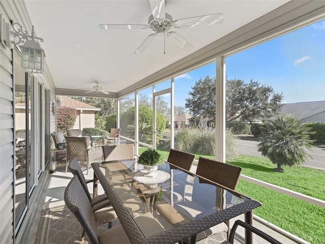 sunroom featuring ceiling fan