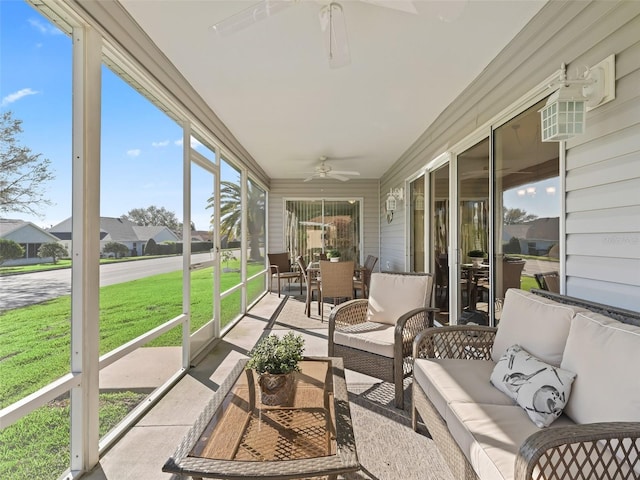 sunroom / solarium featuring ceiling fan