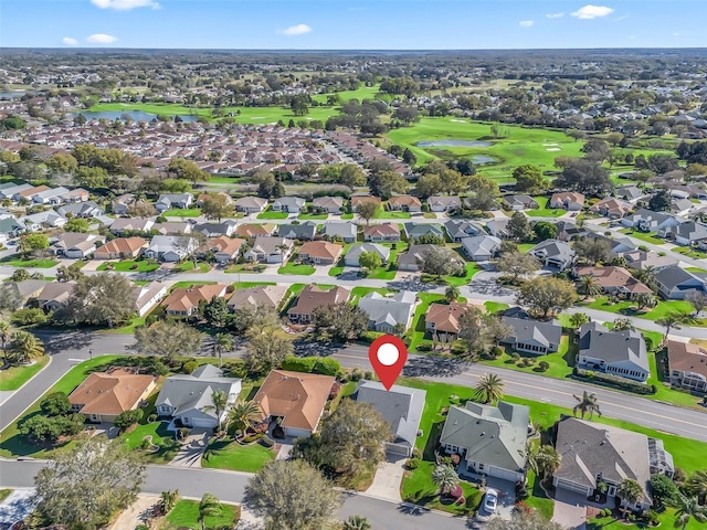 aerial view with a residential view, view of golf course, and a water view