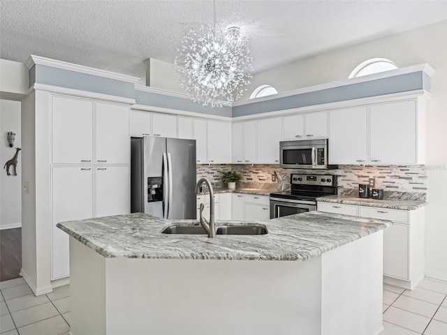 kitchen featuring light tile patterned floors, backsplash, stainless steel appliances, and a sink