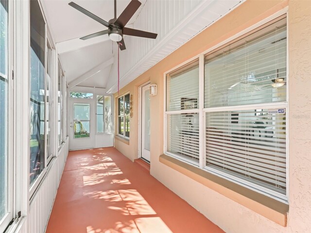 unfurnished sunroom with lofted ceiling and ceiling fan