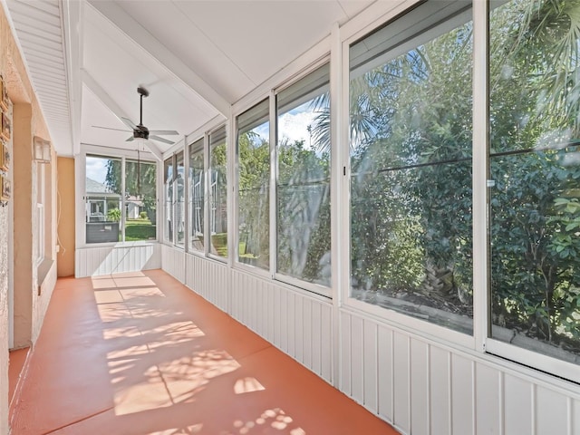 unfurnished sunroom featuring a ceiling fan