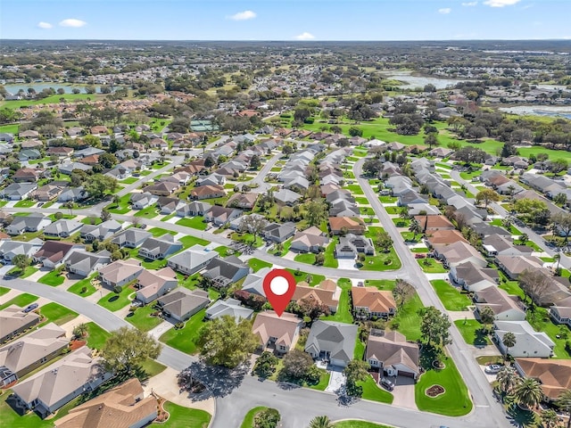 drone / aerial view featuring a residential view and a water view