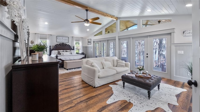 interior space featuring lofted ceiling with beams, access to exterior, wood finished floors, and french doors