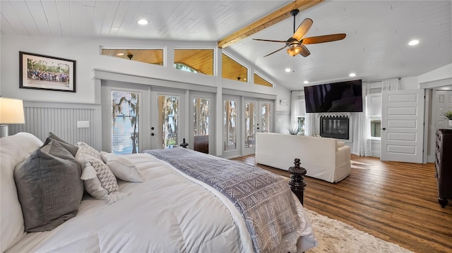 bedroom with access to outside, french doors, vaulted ceiling with beams, and wood finished floors