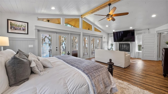 12117 Cypress Ln, Clermont, FL 34711 - bedroom with access to exterior, french doors, wood finished floors, a glass covered fireplace, and recessed lighting