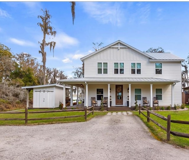 12117 Cypress Ln, Clermont, FL 34711 - view of front facade featuring a porch, a metal roof, a standing seam roof, board and batten siding, and a shed