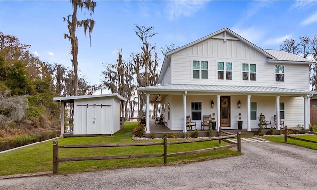 12117 Cypress Ln, Clermont, FL 34711 - view of front facade featuring covered porch, a standing seam roof, a front yard, and a shed