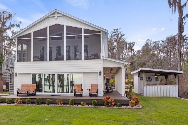 12117 Cypress Ln, Clermont, FL 34711 - back of property with a sunroom, a yard, a wooden deck, and stairway